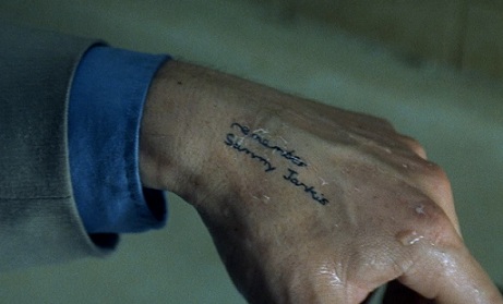 Leonard Shelby's hand from Memento, tattooed with "Remember Sammy Jankis" — the only way to preserve information across memory resets